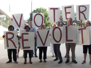 ChangeAustin Supporters holding signs that spell Voter Revolt
